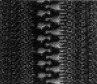 Close-up of a textured surface showcasing a series of interlocking teeth, likely from a zipper.