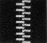 Detailed microscopic view of a zipper's teeth demonstrating its design and functionality;