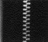 Close-up of a black zipper against a textured background, highlighting the metallic teeth and pull tab,