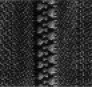Close-up of a black zipper, focusing on the interlocking teeth and textured fabric,