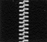 Close-up of a black zipper with white teeth, highlighting the texture and design details.